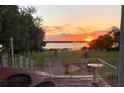 Picturesque sunset view from the back porch overlooking the lake, enhancing this tranquil home's setting at 9023 Silver Lake Dr, Leesburg, FL 34788