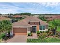 Expansive aerial view of the well-maintained home with lush landscaping and a paver driveway at 453 Treviso Dr, Poinciana, FL 34759