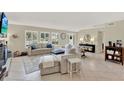 Bright living room with large windows, tile floors, fireplace, and comfortable seating for a cozy atmosphere at 1007 N Shore Dr, Leesburg, FL 34748