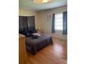 Bright bedroom features hardwood floors, natural light, and neutral paint at 1022 E 3Rd Ave, Mount Dora, FL 32757