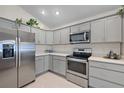 Beautiful kitchen featuring gray cabinets and stainless steel appliances at 11287 Stewart Loop, Oxford, FL 34484