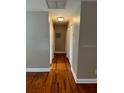 Hallway view featuring hardwood flooring and light-colored walls, creating a clean and spacious feel at 1225 E 1St Ave, Mount Dora, FL 32757