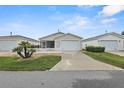 A well-maintained home with a white picket fence, pretty landscaping, and attached one car garage at 1291 Jonesville Ter, The Villages, FL 32162