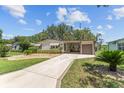 Single-story home featuring well-maintained landscaping and a concrete driveway at 1303 E Schwartz Blvd, The Villages, FL 32159