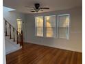 Bright living room with hardwood floors and large windows, creating a warm and inviting atmosphere at 148 W 9Th Ave, Mount Dora, FL 32757