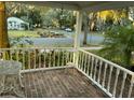 A cozy covered porch with brick flooring and a view of the street, perfect for relaxing at 148 W 9Th Ave, Mount Dora, FL 32757