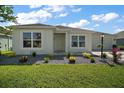 Well-maintained home with lush lawn and colorful landscaping at 1627 Mclucas Ln, The Villages, FL 34762