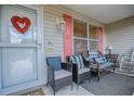 Welcoming front porch featuring comfortable seating and charming decorative accents at 17009 Se 96Th Chapelwood Cir, The Villages, FL 32162