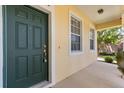 Inviting home entrance featuring a secure green door and a well-lit, covered porch at 2064 Rafton Rd, Apopka, FL 32703