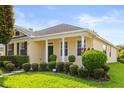 Inviting exterior view of the house showcasing its lush landscaping, columns and well-manicured lawn at 2064 Rafton Rd, Apopka, FL 32703