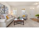 Cozy living room with neutral decor, plush seating, and bright natural light from two large windows at 2064 Rafton Rd, Apopka, FL 32703