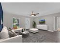 Bright living room featuring modern furniture, wood flooring and large windows at 209 Edgewood Dr, Clermont, FL 34711