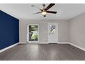 Living room with wood flooring, ceiling fan, natural lighting and neutral paint at 209 Edgewood Dr, Clermont, FL 34711