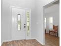 Bright foyer with decorative tile floors, high ceilings, and a beautiful front door at 21926 King Alfred St, Leesburg, FL 34748