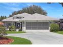 Beautiful single-Gathering home showcasing a pristine, landscaped front yard and an attached two-car garage at 21926 King Alfred St, Leesburg, FL 34748