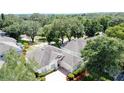Aerial view of the home with mature trees at 2415 Twickingham Ct, Clermont, FL 34711