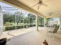 Screened patio with ceiling fans and seating area, perfect for outdoor enjoyment at 2415 Twickingham Ct, Clermont, FL 34711