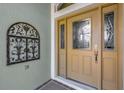 Close up of front door with side windows and security door at 2568 Jupiter Way, The Villages, FL 32163