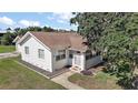 Quaint home featuring a manicured lawn, sidewalk, and mature trees at 30 E Key Ave, Eustis, FL 32726