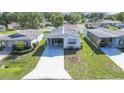 An aerial view of the charming home in a well-maintained community and beautiful landscaping at 32335 Oak Park Dr, Leesburg, FL 34748