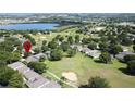 Expansive view of a neighborhood near a lake and golf course, showcasing its community layout at 3559 Chapel Hill Blvd, Clermont, FL 34711