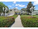 Inviting home with manicured front yard, features walkway, and well-maintained landscaping at 397 Anderson Dr, Tavares, FL 32778