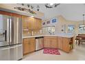Bright kitchen with stainless steel appliances, light wood cabinets, and tile flooring at 397 Anderson Dr, Tavares, FL 32778