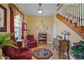 Comfortable sitting room featuring hardwood floors, cozy seating, and staircase to second level at 397 Anderson Dr, Tavares, FL 32778