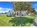 Well-maintained home with manicured lawn, mature trees, and a paved driveway on a sunny day at 4716 Block Island Ln, Clermont, FL 34714