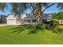 Charming single-Gathering home features a well-manicured lawn, two-car garage, and welcoming front porch at 508 Woodview Dr, Tavares, FL 32778
