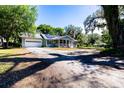 Charming single-story house with a screened porch, solar panels, and a spacious driveway at 513 Barwick St, Wildwood, FL 34785