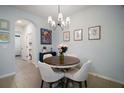 Cozy dining area with a round table, chandelier lighting, and stylish decor at 5333 Loblolly Ln, Wildwood, FL 34785
