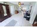 Open-concept living room featuring tile flooring and neutral wall colors at 603 W Seminole Ave, Eustis, FL 32726