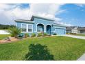 Charming blue single Gathering home with well manicured landscaping at 6042 Claystone Way, Mount Dora, FL 32757