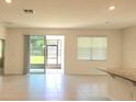 Spacious living room featuring tile flooring, and sliding glass doors leading to the outside at 6203 Sw 93Rd Loop, Ocala, FL 34476