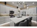Bright kitchen featuring stainless steel appliances, quartz countertops, and a large center island with counter seating at 6243 Danielson Loop, The Villages, FL 32163