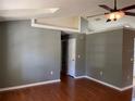Spacious living room featuring vaulted ceilings, hardwood floors, a ceiling fan and neutral walls at 825 Mary Frank Ct, Mount Dora, FL 32757