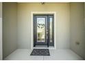 Close-up of the beautiful front door with glass detailing and a decorative wreath at 8652 Se 133Rd Ln, Summerfield, FL 34491