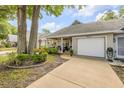 Lovely home with a cozy front porch, an attached one car garage, and mature trees at 8712 Sw 92Nd Pl # D, Ocala, FL 34481