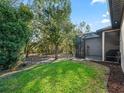 Spacious backyard featuring a screened-in porch and a fully fenced-in yard with mature trees at 10994 Se 168Th Loop, Summerfield, FL 34491