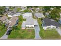 Aerial view of a well-maintained single-story home with a carport and landscaped yard in a residential area at 1146 W Boone Ct, Lady Lake, FL 32159