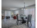 Open-concept living and dining area featuring wood flooring and abundant natural light at 1202 Fernando Ln, The Villages, FL 32159