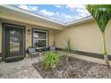 Inviting front entrance with chairs, a window, and landscaping that adds curb appeal at 1204 Monterey Dr, Eustis, FL 32726