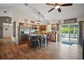 Spacious kitchen with island seating, stainless steel appliances, and sliding doors to the pool area at 1204 Monterey Dr, Eustis, FL 32726