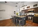 Well-equipped kitchen featuring an island with bar seating, stainless appliances, and stylish granite countertops at 1204 Monterey Dr, Eustis, FL 32726