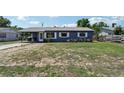 Charming single-story home with gray exterior, metal roof, and well-maintained yard at 1406 Hope Ct, Tavares, FL 32778