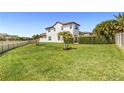 Expansive backyard with lush green lawn, white fence, and well-maintained landscaping at 14907 Guava Bay Dr, Winter Garden, FL 34787