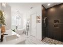 Modern bathroom with a standalone tub, walk-in shower with dual showerheads, and marble flooring at 1560 Ne 17Th St, Sumterville, FL 33585