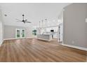 Open-concept living space flows into a kitchen with an island and stainless appliances at 201 Hillside Ave, Umatilla, FL 32784