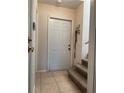 Bright entryway showcasing tile flooring and staircase to the upper level at 206 Orchid Dr, Davenport, FL 33897